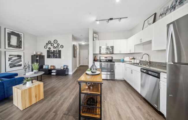 A modern kitchen with stainless steel appliances and a wooden island.
