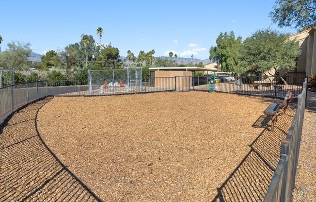 Fenced dog park area with waste disposal station