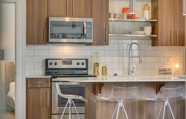 a kitchen with white tile and wooden cabinets