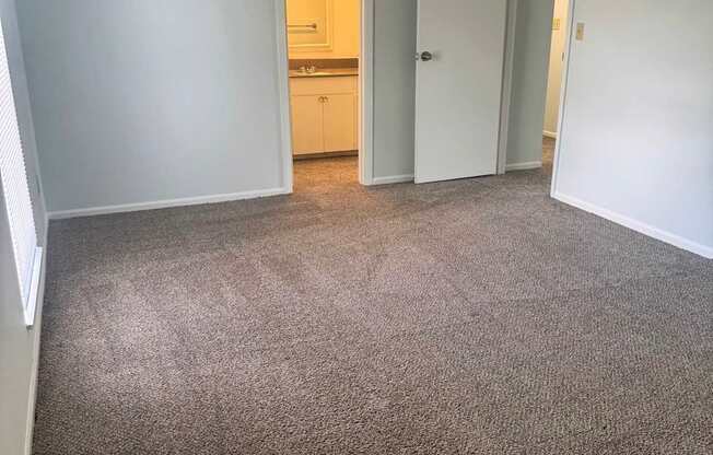 A room with carpeted floor and white walls.