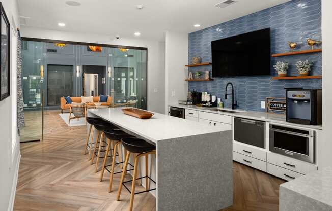 a kitchen with a large island and a counter top with chairs