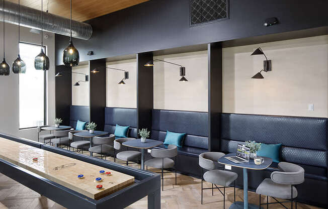 The game room features a lounge-style seating area and social environment