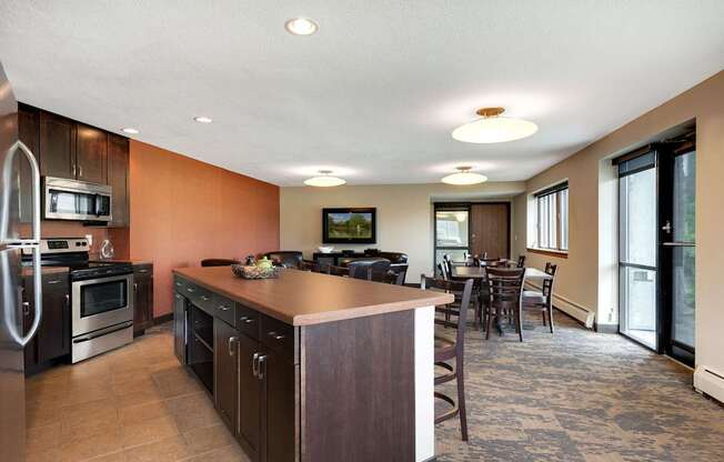 A kitchen with a refrigerator, oven, and microwave.