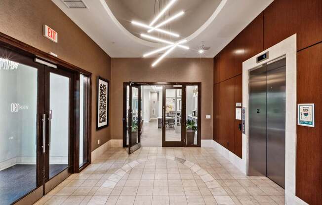 A hallway with a tiled floor and a ceiling with lights.