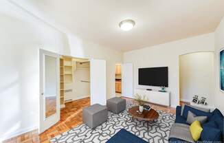 living area with hardwood flooring, social seating, coffee table and tv at baystate apartments in washington dc