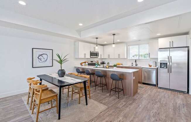 an open kitchen and dining area with a table and chairs