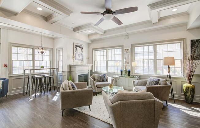 a living room filled with furniture and a ceiling fan