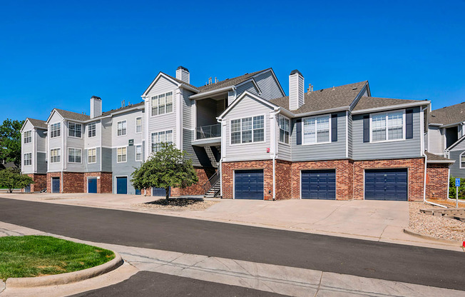 A row of houses with blue garage doors.