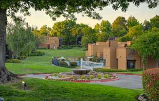 A building with a fountain in front of it.