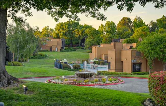 A building with a fountain in front of it.