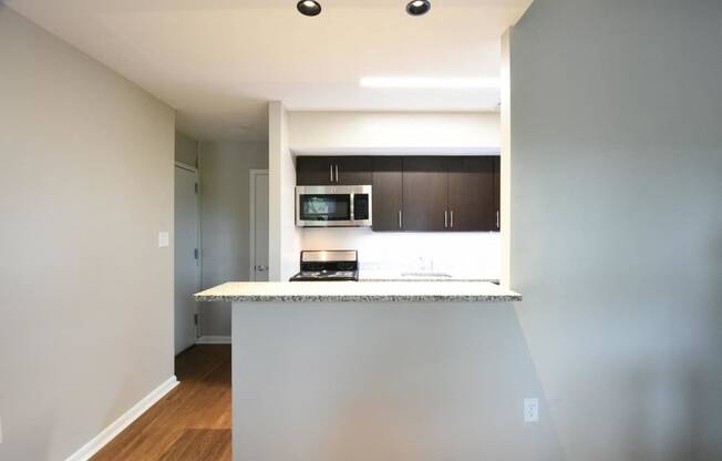 a kitchen with a counter top and a stove top oven