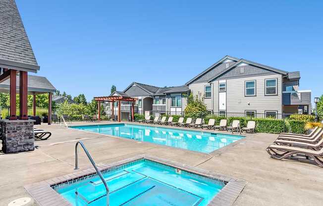 A swimming pool with an apartment building in the background at The Landing Apartments and Townhomes, Oregon, 97045