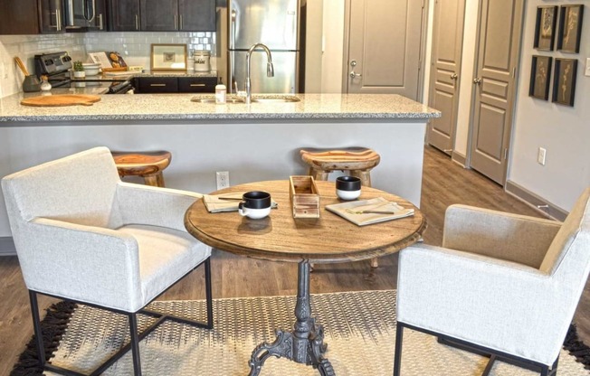 a kitchen with a table and chairs in front of a counter