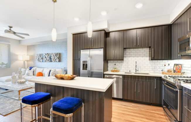 an open kitchen and living room with a white counter top