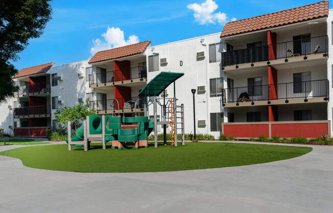 a playground in the middle of an apartment courtyard