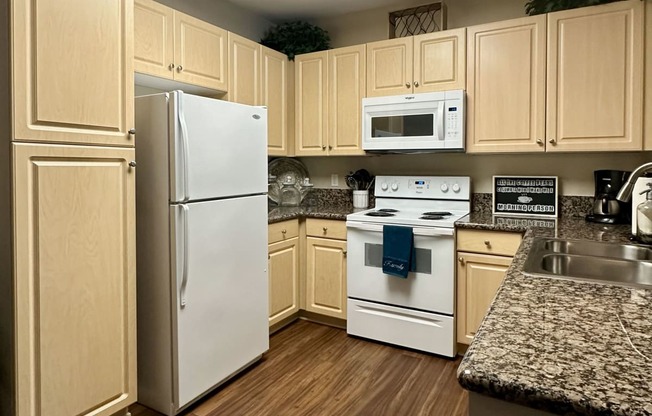 a kitchen with white appliances and wooden cabinets