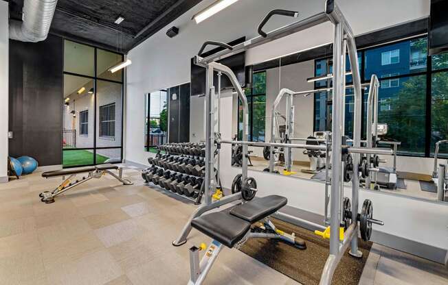 a gym with weights and cardio equipment at aria on the avenue apartments