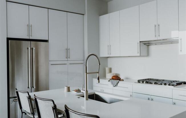 a kitchen with white cabinets and a white counter top