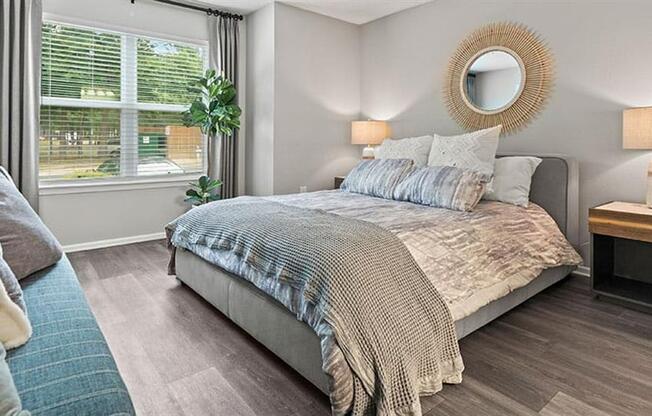 a bedroom with a bed and a large window at Trails at Short Pump Apartments, Richmond ,23233