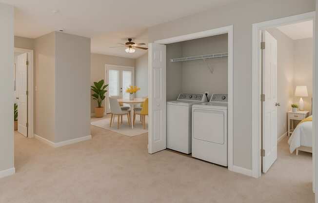A white laundry room with a washer and dryer.