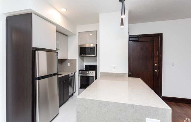 a kitchen with stainless steel appliances and a large island