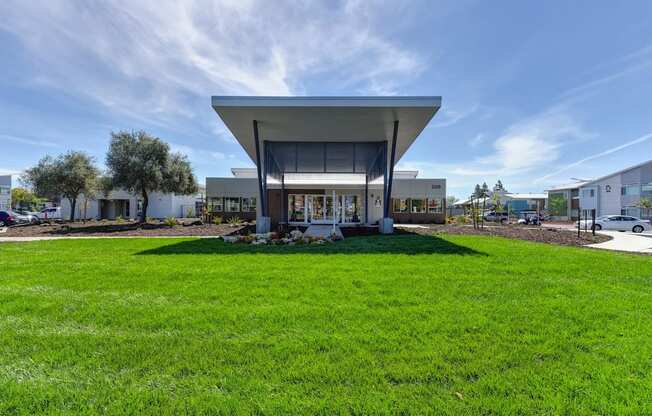 Apartment Exterior with Grass, Trees, Walking Path, Cars
