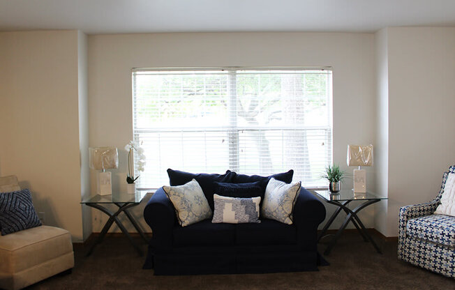 a living room with a couch in front of a window