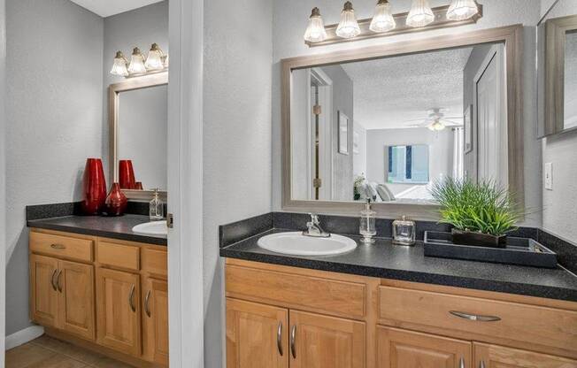 Double vanity with two sinks and light brown shaker cabinetry