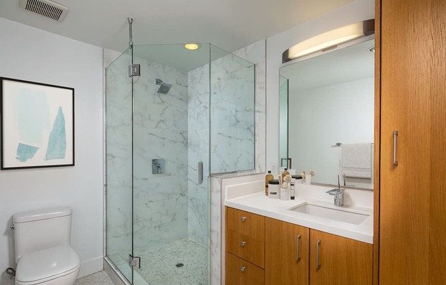 a bathroom with a toilet sink and shower