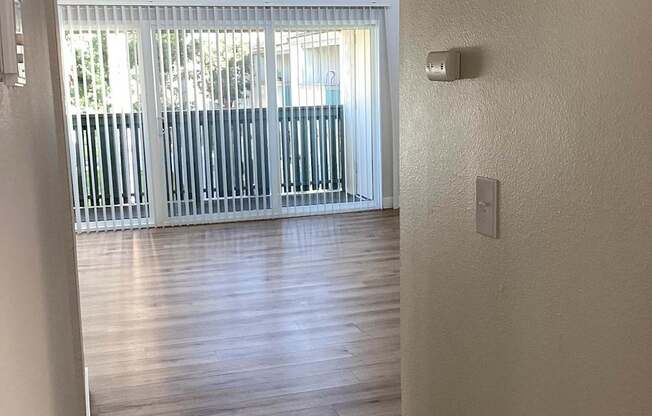 A white door with a window in the background.