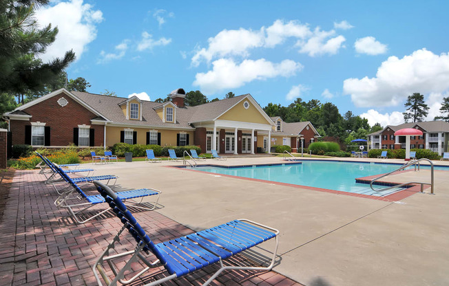 Swimming pool with lounge chairs, tanning deck.