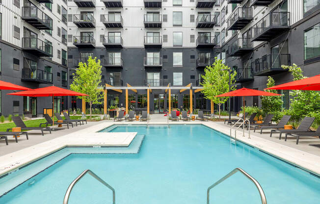 a swimming pool in front of an apartment building