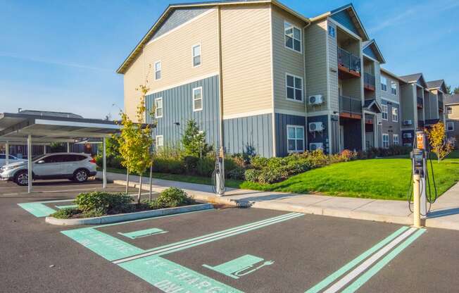 an empty parking lot in front of an apartment building