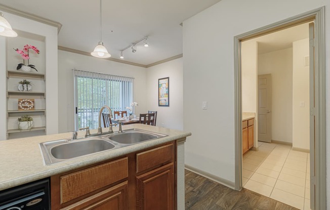 a kitchen with a sink and a doorway to a dining room