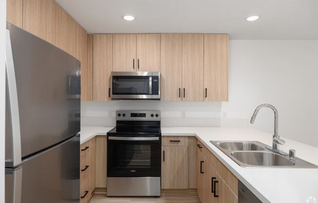 a kitchen with stainless steel appliances and wooden cabinets