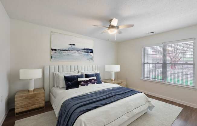 a bedroom with a bed and a ceiling fan