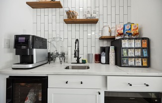 a kitchen with white cabinets and a white tile backsplash