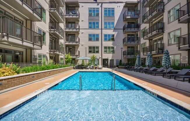 a swimming pool in the middle of an apartment building at Link Apartments® 4th Street, Winston-Salem, NC