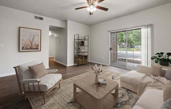 A living room with a sofa, a chair, a coffee table, and a painting on the wall.