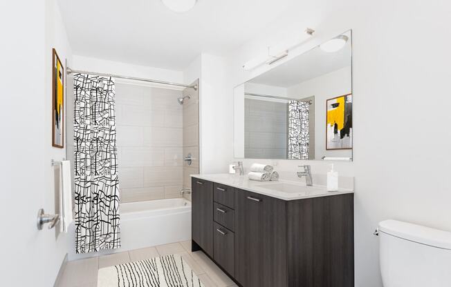 a white bathroom with a black and white shower at One 333, Chicago, IL, 60605