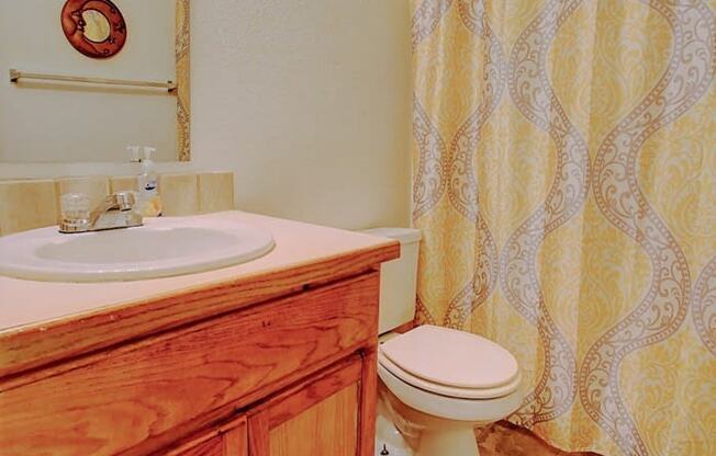 Image of bathroom with vanity, toilet, and bathtub