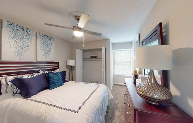 a bedroom with a large bed and a ceiling fan