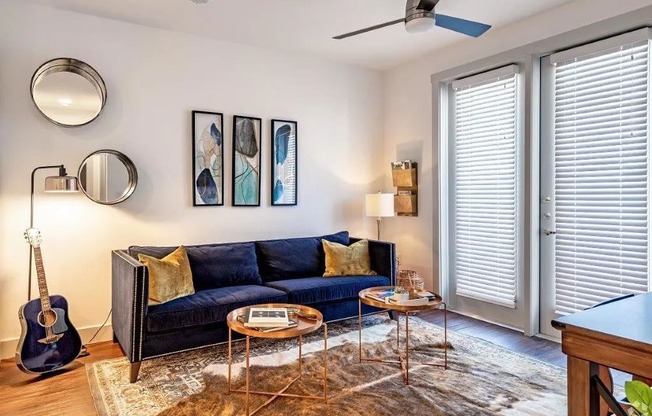 a living room with a couch and a guitar in it