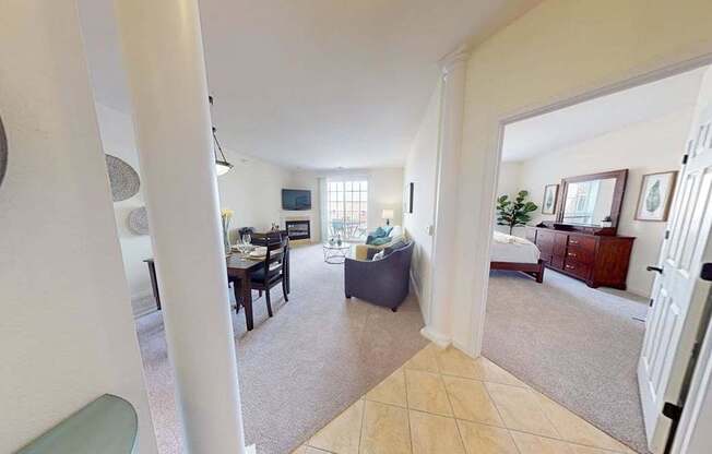 A living room with a couch, a chair, and a television.