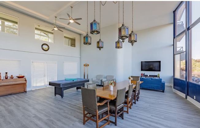 a large room with a ping pong table and a flat screen tv