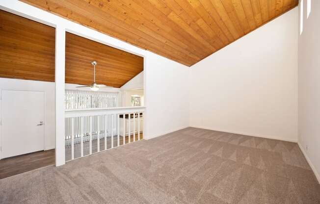 a living room with a carpeted floor and a balcony