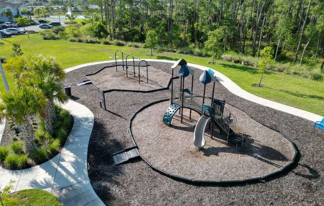 a playground is shown in a park with trees