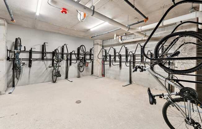 A bike shop with many bicycles hanging on the wall.