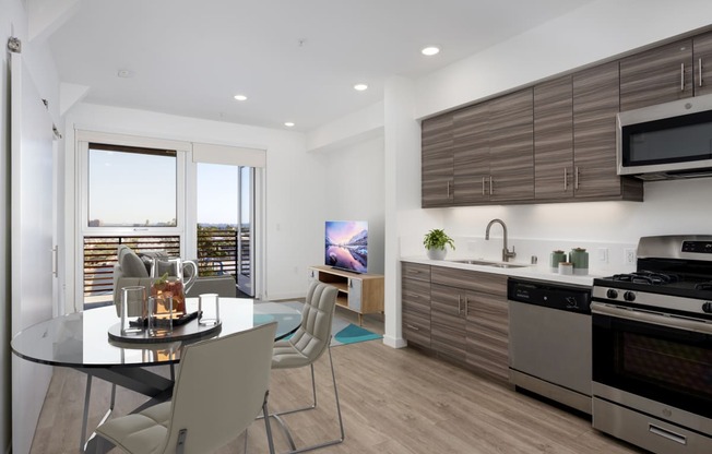 a kitchen and dining room with a glass table and chairs