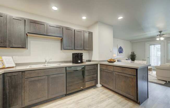 a kitchen with wooden cabinets and a counter top and a sink at Madison Park, Bozeman